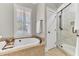 Bathroom boasts a tub with a tiled surround and a glass-enclosed shower at 1626 Bull Creek Ln, Charleston, SC 29414