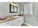 Bathroom with white cabinets, granite counters, and a large mirror above the sink at 1626 Bull Creek Ln, Charleston, SC 29414