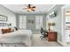 Comfortable bedroom featuring a bed, desk area, large windows, and a ceiling fan at 1626 Bull Creek Ln, Charleston, SC 29414