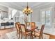 Formal dining room featuring hardwood floors, chandelier, white trim and plantation shutters at 1626 Bull Creek Ln, Charleston, SC 29414