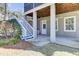 Exterior view featuring a set of stairs leading to a porch with white railings and a neatly landscaped yard at 1626 Bull Creek Ln, Charleston, SC 29414