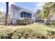 A two-story home with a screened porch and well-maintained lawn with mature trees at 1626 Bull Creek Ln, Charleston, SC 29414
