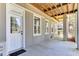 Exterior view of the home with a concrete patio, multiple windows, door and exposed beams at 1626 Bull Creek Ln, Charleston, SC 29414