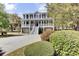 Stately two-story home with a white picket fence, covered porch, and well-manicured landscaping at 1626 Bull Creek Ln, Charleston, SC 29414