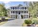 Elegant two-story home featuring a grand entrance, covered porch, and beautifully landscaped yard at 1626 Bull Creek Ln, Charleston, SC 29414