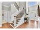Staircase with wood treads and ornate metal railings leads to the upper level at 1626 Bull Creek Ln, Charleston, SC 29414