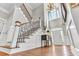 Grand foyer features a high ceiling, chandelier, staircase, and hardwood floors at 1626 Bull Creek Ln, Charleston, SC 29414