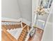 Bright foyer features wood stairs, ornamental iron railing, and large window with custom chandelier at 1626 Bull Creek Ln, Charleston, SC 29414