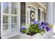 Charming front porch featuring a beautiful flower box with colorful pansies and classic black shutters at 1626 Bull Creek Ln, Charleston, SC 29414