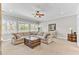 Living room with neutral palette, ceiling fan, and many windows for natural light at 1626 Bull Creek Ln, Charleston, SC 29414