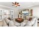 Comfortable living room includes built-in shelving, ceiling fan, and views to the entry foyer at 1626 Bull Creek Ln, Charleston, SC 29414