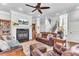 Comfortable living room with fireplace, leather seating, wood floors and a ceiling fan at 1626 Bull Creek Ln, Charleston, SC 29414