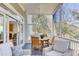 Relaxing screened porch featuring a wooden dining set, ceiling fan, and comfortable seating, with a view of the backyard at 1626 Bull Creek Ln, Charleston, SC 29414