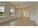 Elegant dining room with hardwood floors, large windows, and modern chandelier lighting perfect for entertaining at 197 Belfort Pl, Summerville, SC 29486