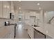 Well-lit kitchen with stainless appliances, quartz countertops, subway tile backsplash, and generous cabinet space at 197 Belfort Pl, Summerville, SC 29486