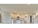 Modern kitchen featuring white cabinets, a center island with sink, and open layout into living area at 197 Belfort Pl, Summerville, SC 29486
