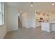 Open-concept living room with hardwood floors, leading to a modern kitchen with white cabinetry at 197 Belfort Pl, Summerville, SC 29486