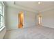 Spacious main bedroom with tray ceiling, adjoining bathroom, and carpeted flooring for comfort at 197 Belfort Pl, Summerville, SC 29486