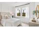 Light-filled bedroom featuring a plush bed, neutral decor, and views to the lush surroundings at 198 Belfort Pl, Summerville, SC 29486