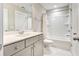 Well-lit bathroom featuring a bathtub with shower, a sink, and toilet with marble flooring at 1984 Shadetree Blvd, Johns Island, SC 29455