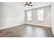 Spacious bedroom featuring hard wood floors, neutral walls, a ceiling fan, and two windows at 1984 Shadetree Blvd, Johns Island, SC 29455