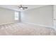 Empty bedroom with neutral carpet, light grey walls, two windows, and a door at 1984 Shadetree Blvd, Johns Island, SC 29455