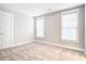 Spacious bedroom with two windows, carpet flooring, and a double-door closet at 1984 Shadetree Blvd, Johns Island, SC 29455