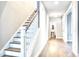 Hallway with staircase, wood floors, and a convenient powder room under the stairs at 1984 Shadetree Blvd, Johns Island, SC 29455