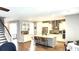 Open-concept kitchen with white cabinetry, stainless steel appliances, and a large center island with bar stool seating at 1984 Shadetree Blvd, Johns Island, SC 29455