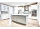 Well-equipped kitchen with white cabinets, stainless steel appliances, and a large island perfect for cooking and entertaining at 1984 Shadetree Blvd, Johns Island, SC 29455