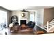 Cozy living room with fireplace, ceiling fan, and staircase, offers comfort and style at 1984 Shadetree Blvd, Johns Island, SC 29455