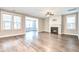 Open living room with a fireplace, ceiling fan, and natural light from large windows at 1984 Shadetree Blvd, Johns Island, SC 29455