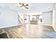 Spacious living room flowing into a modern kitchen, featuring hardwood floors and ample natural light for a welcoming atmosphere at 1984 Shadetree Blvd, Johns Island, SC 29455