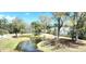 Scenic pond with mature trees, lush greenery, and serene water creating a tranquil environment at 1984 Shadetree Blvd, Johns Island, SC 29455