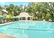 Community pool featuring a mushroom fountain, lounge chairs, and shaded areas for relaxation at 1984 Shadetree Blvd, Johns Island, SC 29455