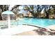 Community pool with a mushroom fountain, lounge chairs, and umbrellas for a relaxing experience at 1984 Shadetree Blvd, Johns Island, SC 29455