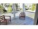 Outdoor porch with comfortable wooden chairs offers a relaxing space to enjoy the view at 1984 Shadetree Blvd, Johns Island, SC 29455