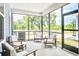 Inviting screened-in porch with comfortable seating, perfect for outdoor relaxation and entertaining at 1984 Shadetree Blvd, Johns Island, SC 29455