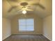 Spacious bedroom with plush carpet, large window, and ceiling fan with lights at 203 Arbor Oaks Dr, Summerville, SC 29485