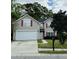 Charming two-story home with a well-maintained lawn, paved driveway, and traditional architectural details at 203 Arbor Oaks Dr, Summerville, SC 29485