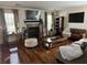 Cozy living room with a fireplace, hardwood floors, and comfortable seating at 203 Arbor Oaks Dr, Summerville, SC 29485