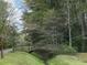 A well-maintained path leads to a quaint wooden bridge surrounded by lush greenery at 203 Arbor Oaks Dr, Summerville, SC 29485