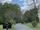 Entrance to the 'Sawmill Branch Trail' surrounded by lush greenery at 203 Arbor Oaks Dr, Summerville, SC 29485
