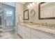 Bright bathroom featuring double sinks, granite countertop and three decorative mirrors at 2072 Middleburg Ln, Mount Pleasant, SC 29464