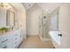 Bright bathroom features a walk-in shower with white marble surround and a free standing tub at 2072 Middleburg Ln, Mount Pleasant, SC 29464