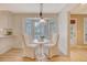 Bright breakfast nook features a bay window, pendant lighting and classic white chairs at 2072 Middleburg Ln, Mount Pleasant, SC 29464