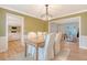 Dining room features wood floors, bright lighting, and a wooden table with seating for four at 2072 Middleburg Ln, Mount Pleasant, SC 29464