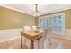 Dining room features wood floors, bright lighting, and a wooden table with seating for four at 2072 Middleburg Ln, Mount Pleasant, SC 29464
