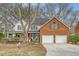 Charming two-story home featuring a brick facade, two-car garage, and a welcoming front porch at 2072 Middleburg Ln, Mount Pleasant, SC 29464