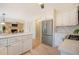 Open-concept kitchen featuring white cabinetry, stainless steel appliances, and hardwood floors at 2072 Middleburg Ln, Mount Pleasant, SC 29464